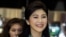 FILE - Former Thai Prime Minister Yingluck Shinawatra smiles as she arrives at Bangkok's Suvarnabhumi Airport, July 23, 2014.