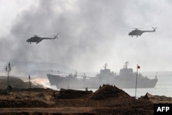 Russia's navy ships and helicopters take part in a military exercise “Kavkaz” 2016 at the coast of the Black Sea in Crimea on September 9, 2016.
