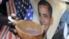 A person holds a bowl of porridge against a poster of U.S. President Barack Obama as Kenyans celebrate his re-election in Nairobi's Kibera slums, November 7, 2012. 