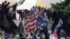 Protesters destroy an American flag pulled down from the U.S. embassy in Cairo, September 11, 2012.