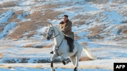 (FILES) This undated file picture released by the Korean Central News Agency on October 16, 2019 shows North Korean leader Kim Jong Un riding a white horse amongst the first snow at Mouth Paektu. - North Korean leader Kim Jong Un is "alive and well"…