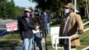 Early voters wait to cast their ballots at the South Regional Library polling location in Durham, N.C., Oct. 15, 2020. 