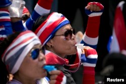Anti-government protesters blow whistles as hundreds follow their leader Suthep Thaugsuban (not pictured) protesting at the Teachers Council of Thailand in central Bangkok, April 4, 2014.