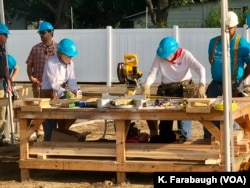 Former President Jimmy Carter and first lady Rosalyn Carter work on a Habitat for Humanity home for Ericka Santiestepan and her two young children in Mishawaka, Ind.