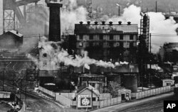 FILE – In this September 1980 file photo, a Jones and Laughlin Steel Corp. coke plant is wreathed in smoke and steam in Struthers, Ohio.