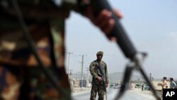 Afghan National Army soldiers stand guard at a checkpoint on the Jalalabad-Kabul road, on the outskirts of Kabul, April 28, 2019.