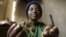 FILE - Zimbabwean healer Martha Katsande shows a traditional medicine used in her surgery practice, Harare.