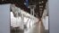 In this March 27, 2020 photo provided by Office of Governor Andrew M. Cuomo, makeshift hospital rooms stretch out along the floor at the Jacob Javits Convention Center in New York.