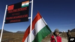 一名印度女孩在中印边界线附近手持印度国旗