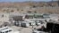 Shops, front right, and vehicles are seen at Ghulam Khan border checkpoint in Pakistan Tuesday, Jan. 7, 2003. More than a week after a disagreement with the United States over American military "hot pursuit" reaching over Afghanistan's edge, this remote c