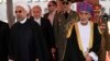 FILE - Oman's Sultan Qaboos bin Said (R) walks with Iran's President Hassan Rouhani upon Rouhani's arrival in Muscat, Oman, March 12, 2014.