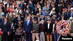 French President Emmanuel Macron and U.S President Donald Trump stand during a ceremony to mark the 75th anniversary of the D-Day at the Normandy American Cemetery and Memorial in Colleville-sur-Mer, France, June 6, 2019.