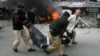 Pakistani police officers and a volunteer rush an injured person to a hospital after a bombing in Lahore, Pakistan, Feb. 17, 2015. 
