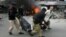 Pakistani police officers and a volunteer rush an injured person to a hospital after a bombing in Lahore, Pakistan, Feb. 17, 2015. 