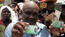Haitian Jaquenol Martinez shows a card that proves that he has worked in the Dominican sugar cane fields since 1963, while trying to apply for a temporary resident permit, in Santo Domingo, Dominican Republic, June 15, 2015.