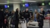 Foreign diplomats, embassy staff, and their families check-in for a flight to Vladivostok at Pyongyang International Airport on March 9, 2020. - Several embassies in North Korea closed as many diplomats were flown out following weeks of tight…