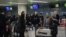 Foreign diplomats, embassy staff, and their families check-in for a flight to Vladivostok at Pyongyang International Airport on March 9, 2020. - Several embassies in North Korea closed as many diplomats were flown out following weeks of tight…