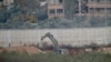 Israeli military digger works on the border with Lebanon in the northern Israeli town of Metula, Tuesday, Dec. 4, 2018. The Israeli military launched an operation on Tuesday to "expose and thwart" tunnels built by Hezbollah it says stretch from Lebanon into northern Israel.