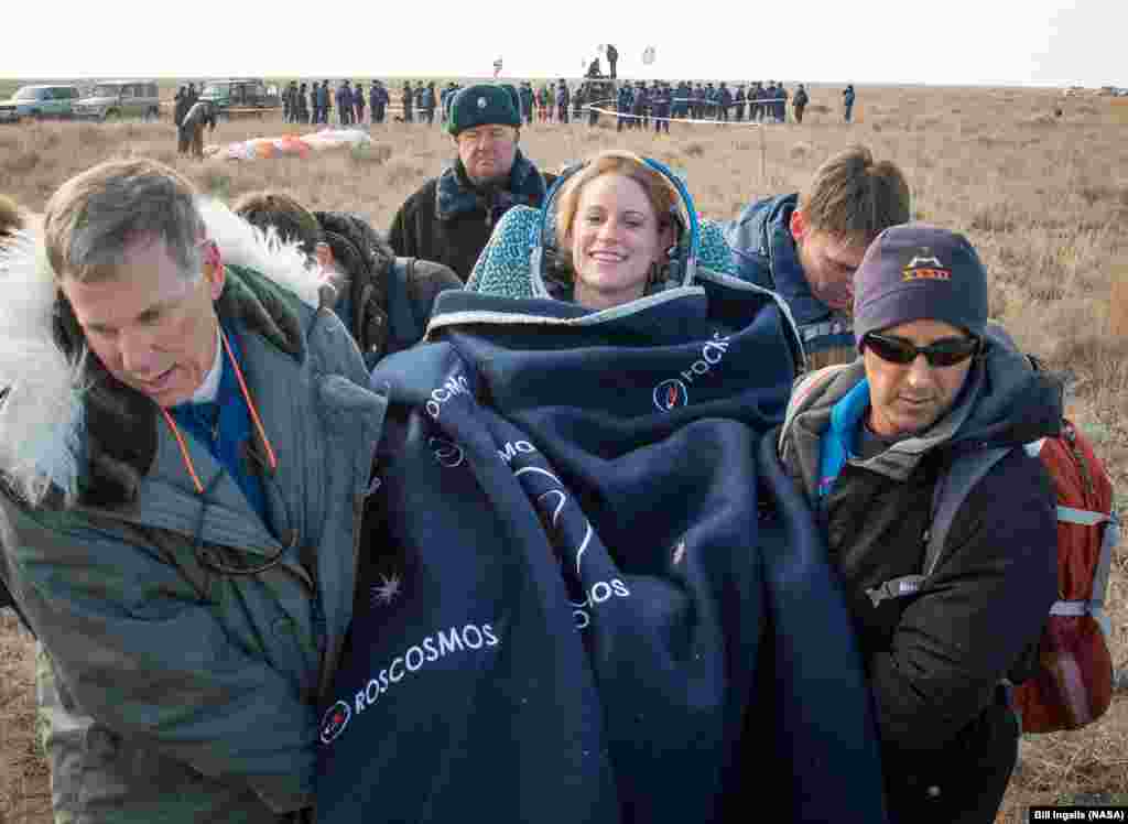 Expedition 49 NASA astronaut Kate Rubins is carried into a medical tent shortly after she, Russian cosmonaut Anatoly Ivanishin of Roscosmos, and astronaut Takuya Onishi of the Japan Aerospace Exploration Agency (JAXA) landed in a remote area near the town&nbsp;of Zhezkazgan, Kazakhstan.
