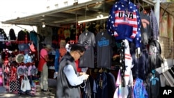 A tourist from China looks at travel souvenirs at a kiosk in Washington, D.C., Oct. 15, 2019.