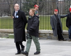 Sierra Club Executive Director Michael Brune is arrested outside the White House in Washington, Feb. 13, 2013, as prominent environmental leaders tied themselves to the White House gate to protest the Keystone XL oil pipeline.