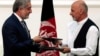 FILE - Afghan rival presidential candidates Abdullah Abdullah (L) and Ashraf Ghani exchange signed agreements for the country's unity government in Kabul, Sept. 21, 2014.
