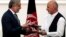 FILE - Afghan rival presidential candidates Abdullah Abdullah (L) and Ashraf Ghani exchange signed agreements for the country's unity government in Kabul, Sept. 21, 2014.