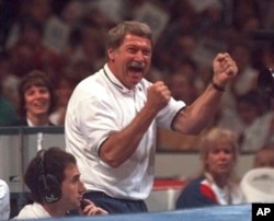 FILE - Bela Karolyi reacts with joy as his gymnastics student Kerri Strug finishes a routine on the balance beam during the optional portion of the US Olympic Trials in gymnastics, June 30, 1996, in Boston.