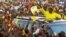 FILE - Uganda's president and presidential candidate Yoweri Museveni of the ruling party National Resistance Movement waves to his supporters as he arrives at a campaign rally in Entebbe, Uganda, Feb. 10, 2016.