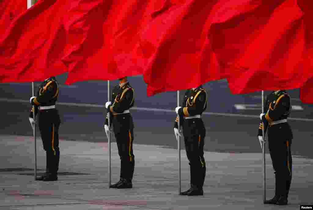 Soldiers of the People&#39;s Liberation Army&#39;s guard of honor hold flags in front of Beijing&#39;s Tiananmen Square during the official welcoming ceremony for Serbian President Tomislav Nikolic outside the Great Hall of the People. 