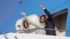 U.S. President Barack Obama and first lady Michelle Obama wave as they depart Waterkloof Air Base for a flight to Cape Town, June 30, 2013, in Centurion, South Africa. 