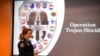 Commander Xenia Cotter, from the Australian Federal Police, walks past an Operation Trojan Shield logo during a news conference, in San Diego, June 8, 2021. 