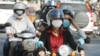 Cambodians wear masks to avoid the contact of coronavirus in Phnom Penh, Cambodia, Tuesday, Jan. 28, 2020. (AP Photo/Heng Sinith