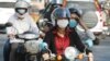 FILE - Cambodians wear masks to avoid the contact of coronavirus in Phnom Penh, Cambodia, Tuesday, Jan. 28, 2020. (AP Photo/Heng Sinith