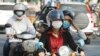 FILE - Cambodians wear masks to avoid the contact of coronavirus in Phnom Penh, Cambodia, Tuesday, Jan. 28, 2020. 