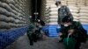 Soldiers check rice stocks at a warehouse in Ayutthaya province, north of Bangkok, Thailand, July 3, 2014. 