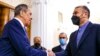 In this photo released by the Russian Foreign Ministry Press Service, Russian Foreign Minister Sergey Lavrov, left, shakes hands with Iranian Foreign Minister Hossein Amirabdollahian prior to their talks in Moscow, Russia, Jan. 20, 2022.