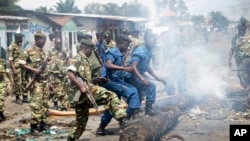 Des policiers et des militaires démontent des barricades dans Bujumbura, 25 mai 2015.