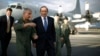 Australian Prime Minister Tony Abbott is guided around a Royal Australian Air Force P-3C Orion aircraft by Australian Air Force Group Commander Craig Heap, second from left, in Bullsbrook, near Perth, Australia, March 31, 2014.