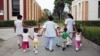 Children walk with social workers at the Puericultorio Perez Aranibar children's home in Lima, Peru, March 9, 2012. 