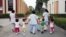 Children walk with social workers at the Puericultorio Perez Aranibar children's home in Lima, Peru, March 9, 2012. 