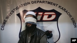 Pakistan officials present an unnamed, alleged Taliban commander to media shortly after confirming the capture the Afghan Taliban's No. 2 leader commander, Mullah Abdul Ghani Baradar, Karachi, Feb. 17, 2010.