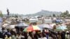 People displaced by recent fighting in eastern Congo wait to receive aid food in Mugunga IDP camp outside of Goma, November 24, 2012. 