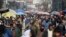 Afghans walk through a crowded market in Kabul, Afghanistan, Feb. 22, 2020.