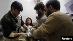 A girl who was injured during a rocket attack receives medical treatment at a hospital in Peshawar, Pakistan, Dec. 15, 2012. 