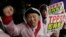 FILE - A protester shouts slogans during a rally against the Trans-Pacific Partnership (TPP) in Tokyo, Tuesday, April 22, 2014.