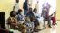 FILE - People wait after receiving the AstraZeneca's COVID-19 vaccine at the National Hospital in Abuja, Nigeria, March 31, 2021.