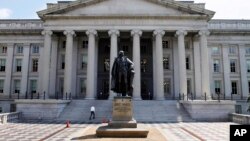 FILE - A statue of former Treasury Secretary Albert Gallatin stands outside the Treasury Building in Washington.