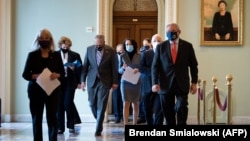 የህግ መወሰኛው ምክር ቤት መሪ የኒዮርኩክ ዴሞክራት ቻክ ሹመር ከሱን ከመሰረቱት የዴሞክራቲክ ህግ አውጭ አባላት ጋር በምክር ቤቱ ህንጻ ውስጥ 