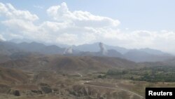 FILE - Smokes rises after U.S airstrike hit the site of insurgent activity in Nangarhar province, Afghanistan, July 7, 2018. 